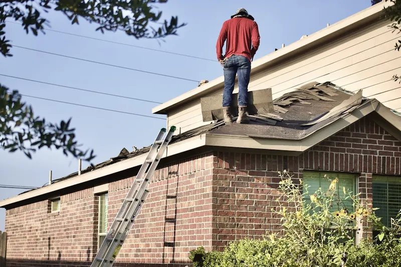 Professional roofer working on a residential roof in St. Robert